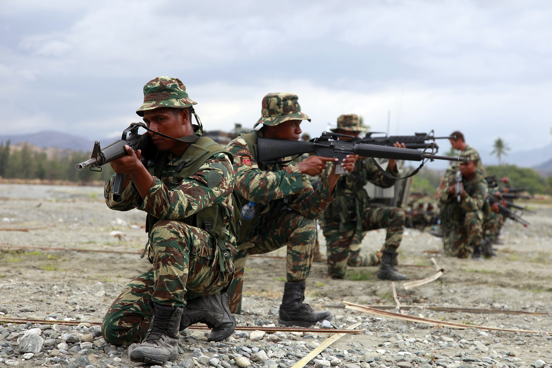 Soldiers with the Timor-Leste Defense Force practice their infantry tactics the evening before the conduct of a raid with India Company, Battalion Landing Team 3/5, 15th Marine Expeditionary Unit, as part of Exercise Crocodilo 2012, Oct. 12. Crocodilo12 serves as the first exercise scheduled during the MEU’s deployment that began on Sept. 17. Throughout the exercise, forces will participate in various events to include field exercises and community relations activities aimed at strengthening the relationship between the US and Timor-Leste. The 15th MEU is currently embarked as part of the Peleliu Amphibious Ready Group, while they serve as the nation's rapid-response sea-based Marine Air Ground Task Force for Western Pacific Deployment 12-02. Soldiers with the Timor-Leste Defense Force practice their infantry tactics the evening before the conduct of a raid with India Company, Battalion Landing Team 3/5, 15th Marine Expeditionary Unit, as part of Exercise Crocodilo 2012, Oct. 12. Crocodilo12 serves as the first exercise scheduled during the MEU’s deployment that began on Sept. 17. Throughout the exercise, forces will participate in various events to include field exercises and community relations activities aimed at strengthening the relationship between the US and Timor-Leste. The 15th MEU is currently embarked as part of the Peleliu Amphibious Ready Group, while they serve as the nation's rapid-response sea-based Marine Air Ground Task Force for Western Pacific Deployment 12-02.